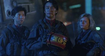 Movie still from “Godzilla vs. Mechagodzilla II” (1993), directed by Kazuki Ômori – A group of people standing next to each other in the dark; Close Up shot, Low angle