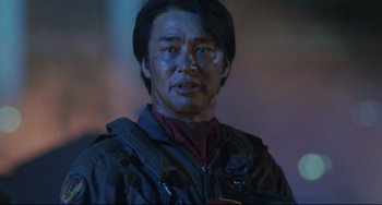 Movie still from “Godzilla vs. Mechagodzilla II” (1993), directed by Kazuki Ômori – A person wearing a jacket; Close Up shot, Low angle