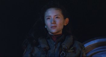 Movie still from “Godzilla vs. Mechagodzilla II” (1993), directed by Kazuki Ômori – A woman in a dark room wearing a jacket; Close Up shot, Low angle