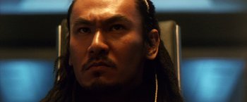 Movie still from “Godzilla: Final Wars” (2004), directed by Koji Hashimoto – A person with long black hair; Close Up shot, Low angle
