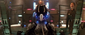 Movie still from “Godzilla: Final Wars” (2004), directed by Koji Hashimoto – A man is standing in front of another man; Close Up shot, Low angle