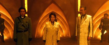 Movie still from “Godzilla: Final Wars” (2004), directed by Koji Hashimoto – A woman standing in front of an archway in a building; Medium shot, Low angle