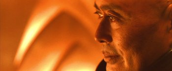 Movie still from “Godzilla: Final Wars” (2004), directed by Koji Hashimoto – A man's face in a dimly - lit room; Extreme Close Up shot, Low angle