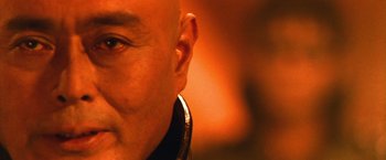 Movie still from “Godzilla: Final Wars” (2004), directed by Koji Hashimoto – A bald man's face with headphones on; Extreme Close Up shot, Low angle