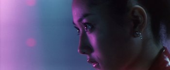 Movie still from “Godzilla: Final Wars” (2004), directed by Koji Hashimoto – A woman's face in a purple light; Extreme Close Up shot, Low angle