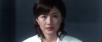 Movie still from “Godzilla: Final Wars” (2004), directed by Koji Hashimoto – A person wearing a white shirt; Close Up shot, Low angle