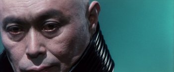 Movie still from “Godzilla: Final Wars” (2004), directed by Koji Hashimoto – A person wearing a neck brace; Extreme Close Up shot, Low angle