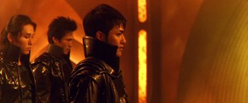 Movie still from “Godzilla: Final Wars” (2004), directed by Koji Hashimoto – A man wearing a leather jacket and a neck guard; Close Up shot, Over the shoulder angle