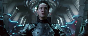 Movie still from “Godzilla: Final Wars” (2004), directed by Koji Hashimoto – A man in a black and silver outfit looking at the camera; Close Up shot, Low angle