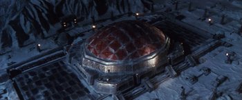 Movie still from “Godzilla: Final Wars” (2004), directed by Koji Hashimoto – An aerial view of a large building with a dome roof; Extreme Wide shot, High angle