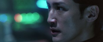 Movie still from “Godzilla: Final Wars” (2004), directed by Koji Hashimoto – A man's face with a blurry background; Close Up shot, Low angle