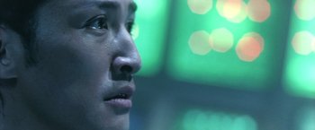 Movie still from “Godzilla: Final Wars” (2004), directed by Koji Hashimoto – A person's face with a blurry background; Extreme Close Up shot, Low angle