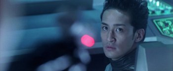 Movie still from “Godzilla: Final Wars” (2004), directed by Koji Hashimoto – A person with a red light in the background; Close Up shot, Low angle