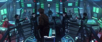 Movie still from “Godzilla: Final Wars” (2004), directed by Koji Hashimoto – A group of people sitting on top of a table; Medium shot, High angle