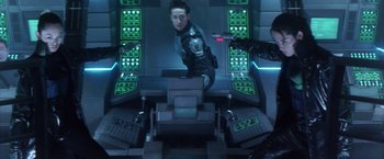 Movie still from “Godzilla: Final Wars” (2004), directed by Koji Hashimoto – A man standing in front of a computer screen; Medium shot, Overhead angle