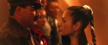 Movie still from “Godzilla: Final Wars” (2004), directed by Koji Hashimoto – A group of people standing next to each other in a room; Close Up shot, Over the shoulder angle