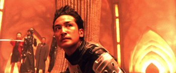 Movie still from “Godzilla: Final Wars” (2004), directed by Koji Hashimoto – A man in a leather jacket looking to his left; Close Up shot, Low angle