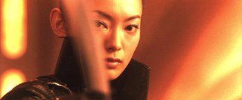 Movie still from “Godzilla: Final Wars” (2004), directed by Koji Hashimoto – A woman's face in a dimly - lit room; Close Up shot, Low angle