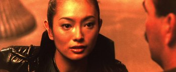 Movie still from “Godzilla: Final Wars” (2004), directed by Koji Hashimoto – A woman's face in a dark room; Close Up shot, Low angle