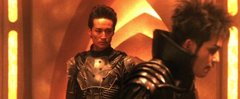 Movie still from “Godzilla: Final Wars” (2004), directed by Koji Hashimoto – A man in a leather suit looking into a mirror; Close Up shot, Over the shoulder angle