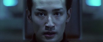 Movie still from “Godzilla: Final Wars” (2004), directed by Koji Hashimoto – A man's face in the dark; Close Up shot, Low angle