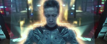 Movie still from “Godzilla: Final Wars” (2004), directed by Koji Hashimoto – A man in a metallic jacket is looking down; Close Up shot, High angle