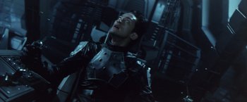 Movie still from “Godzilla: Final Wars” (2004), directed by Koji Hashimoto – A man in a black leather jacket is looking up; Close Up shot, Low angle