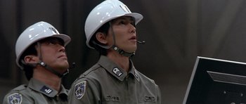 Movie still from “Godzilla: Tokyo S.O.S.” (2003), directed by Takao Okawara – A man wearing a white helmet is wearing a uniform; Close Up shot, Low angle