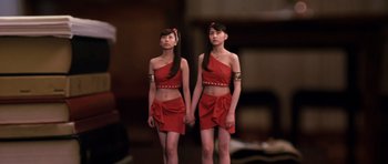 Movie still from “Godzilla: Tokyo S.O.S.” (2003), directed by Takao Okawara – A couple of women standing next to each other holding hands; Medium shot, Low angle