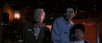 Movie still from “Godzilla: Tokyo S.O.S.” (2003), directed by Takao Okawara – Two men standing next to each other in the dark; Medium shot, Low angle
