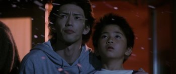Movie still from “Godzilla: Tokyo S.O.S.” (2003), directed by Takao Okawara – Two young men looking at something in the distance; Close Up shot, Low angle