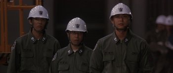 Movie still from “Godzilla: Tokyo S.O.S.” (2003), directed by Takao Okawara – A group of men in military uniforms wearing helmets; Close Up shot, Low angle