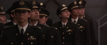 Movie still from “Godzilla: Tokyo S.O.S.” (2003), directed by Takao Okawara – A group of people in military uniforms standing next to each other; Medium shot, Low angle