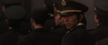 Movie still from “Godzilla: Tokyo S.O.S.” (2003), directed by Takao Okawara – A group of men in uniform standing next to each other; Close Up shot, Over the shoulder angle