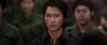 Movie still from “Godzilla: Tokyo S.O.S.” (2003), directed by Takao Okawara – A person wearing a jacket; Close Up shot, Low angle