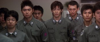 Movie still from “Godzilla: Tokyo S.O.S.” (2003), directed by Takao Okawara – A group of young men standing next to each other; Medium shot, Low angle