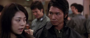 Movie still from “Godzilla: Tokyo S.O.S.” (2003), directed by Takao Okawara – A group of people standing next to each other in a room; Close Up shot, Over the shoulder angle