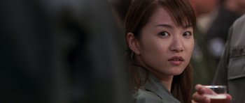 Movie still from “Godzilla: Tokyo S.O.S.” (2003), directed by Takao Okawara – A woman's face in a dark room; Close Up shot, Over the shoulder angle
