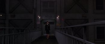 Movie still from “Godzilla: Tokyo S.O.S.” (2003), directed by Takao Okawara – A woman in a uniform walking down a bridge; Extreme Wide shot, Low angle