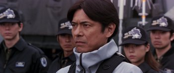 Movie still from “Godzilla: Tokyo S.O.S.” (2003), directed by Takao Okawara – A person wearing a jacket; Close Up shot, Low angle
