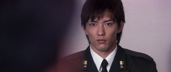 Movie still from “Godzilla: Tokyo S.O.S.” (2003), directed by Takao Okawara – A man in a military uniform is looking at the camera; Close Up shot, Low angle