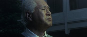 Movie still from “Godzilla: Tokyo S.O.S.” (2003), directed by Takao Okawara – An older man looking up into the sky; Close Up shot, Low angle