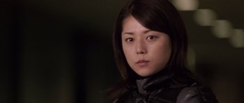 Movie still from “Godzilla: Tokyo S.O.S.” (2003), directed by Takao Okawara – A person wearing a black jacket; Close Up shot, Low angle