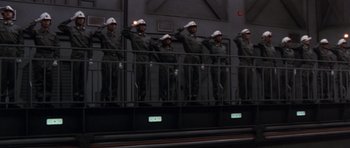 Movie still from “Godzilla: Tokyo S.O.S.” (2003), directed by Takao Okawara – A group of men standing next to each other on top of a building; Wide shot, Low angle
