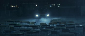 Movie still from “Godzilla: Tokyo S.O.S.” (2003), directed by Takao Okawara – A car is driving through a classroom at night; Extreme Wide shot, High angle