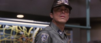Movie still from “Godzilla: Tokyo S.O.S.” (2003), directed by Takao Okawara – A person wearing a uniform; Close Up shot, Low angle