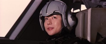 Movie still from “Godzilla: Tokyo S.O.S.” (2003), directed by Takao Okawara – A woman wearing a helmet sitting in an airplane cockpit; Close Up shot, Low angle