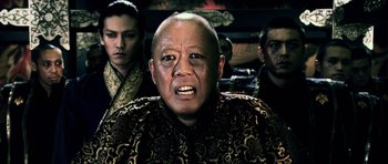 Movie still from “Goemon” (2009), directed by Kazuaki Kiriya – An older man with a bald head is looking at the camera; Close Up shot, Low angle