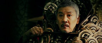 Movie still from “Goemon” (2009), directed by Kazuaki Kiriya – A man holding a pair of scissors in his hand; Close Up shot, Low angle