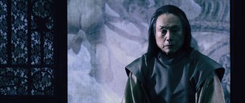 Movie still from “Goemon” (2009), directed by Kazuaki Kiriya – An older man with long black hair wearing a black robe; Close Up shot, Low angle